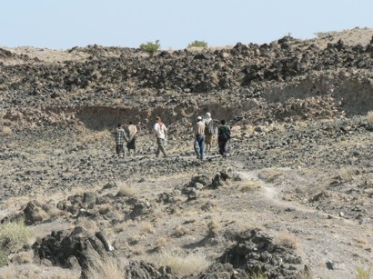 Field team walking towards fresh fault rupture